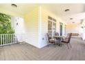 Covered porch featuring a table, chairs, and a swing, offering a relaxing outdoor space at 101 Rainbow Dr, Carrboro, NC 27510