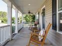 Relaxing covered front porch with rocking chairs, perfect for enjoying the outdoors at 1015 E Maplewood, Benson, NC 27504