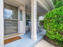 Inviting front porch with rocking chairs, a welcome mat, and tasteful landscaping at 10436 Cokesbury Ln, Raleigh, NC 27614