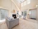 Bright living room featuring a fireplace, vaulted ceilings, and neutral decor at 10436 Cokesbury Ln, Raleigh, NC 27614