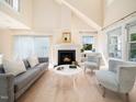 Cozy living room with a fireplace, comfortable seating, and ample natural light at 10436 Cokesbury Ln, Raleigh, NC 27614