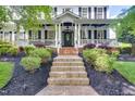 Inviting front entrance with a decorative door, brick steps, and manicured landscaping at 10523 Bedfordtown Dr, Raleigh, NC 27614