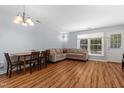 Cozy living room features a large sectional sofa, wood floors, and lots of natural light from large windows at 11 Providence Ct, Durham, NC 27705