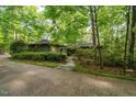 Secluded home surrounded by lush greenery, offering a private and tranquil setting at 11009 Eaglerock Dr, Raleigh, NC 27613