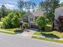 Two-story suburban home with a well-manicured front lawn and driveway leading to an attached garage at 1103 Capstone Dr, Durham, NC 27713