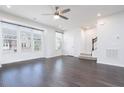 Living room features dark wood floors, recessed lighting, and large bright windows at 114 Cross Country Way, Durham, NC 27703