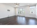 Spacious living room features dark hardwood flooring, recessed lighting, and bright windows at 114 Cross Country Way, Durham, NC 27703
