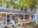 Inviting front exterior showcasing a covered porch with seating and a landscaped garden at 117 Candace Pl, Cary, NC 27513