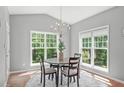 Cozy breakfast nook with a round table, chandelier, and natural light from surrounding windows at 1401 Everette Fields Rd, Morrisville, NC 27560