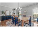 Formal dining room with wood table, blue chairs, stylish rug, and decorative blue console at 1401 Everette Fields Rd, Morrisville, NC 27560