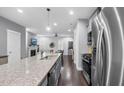 Open kitchen with stainless steel appliances and granite countertops, ideal for cooking and entertaining at 1448 Big Falls Dr, Wendell, NC 27591
