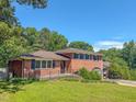 Well-maintained brick home featuring a manicured lawn and inviting curb appeal at 1509 Logan St, Durham, NC 27704