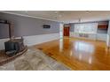 Spacious living room with hardwood floors, a fireplace, and lots of natural light at 1509 Logan St, Durham, NC 27704