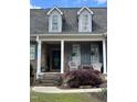 Inviting front porch with classic details, decorative planters, and comfortable seating at 151 Donnibrook, Fuquay Varina, NC 27526