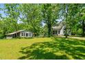 Scenic shot of home with a spacious yard, plus a barn and an enclosed porch outbuilding at 1661 Reno Sharps Store Rd, Bear Creek, NC 27207