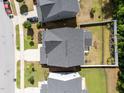 Aerial view of home featuring gray roof, white fence, and landscaped yard at 168 Amber Acorn Ave, Raleigh, NC 27603