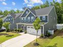 Gorgeous home with two-car garage, a well-kept lawn, and inviting curb appeal at 168 Amber Acorn Ave, Raleigh, NC 27603