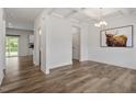 Bright dining area with coffered ceilings, hardwood floors, and a modern chandelier fixture at 170 Creekhaven Dr, Angier, NC 27501