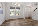 Sun-filled dining room featuring hardwood floors, large windows, and staircase at 170 Creekhaven Dr, Angier, NC 27501