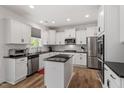 Contemporary kitchen with white cabinets, stainless steel appliances, and dark countertops at 170 Creekhaven Dr, Angier, NC 27501