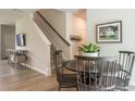 Cozy dining area with a round table, wood chairs, and staircase in background at 171 Alice Trace Place, Angier, NC 27501