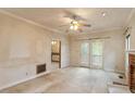 Spacious living room featuring a fireplace, glass doors, and an open view into the adjacent room at 1725 Briarforest Pl, Raleigh, NC 27615