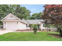 Attractive home with a well-maintained lawn, appealing curb appeal, and attached garage at 1808 Betry Pl, Raleigh, NC 27603