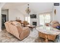 Bright living room featuring vaulted ceilings, fireplace, and elegant furnishings at 1808 Betry Pl, Raleigh, NC 27603