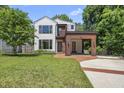 Charming home featuring modern white siding, a wood accent, and a well-manicured lawn at 1820 Park Dr, Raleigh, NC 27605