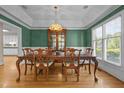 Elegant dining room featuring a large dining table and a built-in china cabinet at 2037 Gurney Ct, Burlington, NC 27215