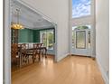 Inviting foyer with gleaming hardwood floors and a grand entry door with sidelights and transom window at 2037 Gurney Ct, Burlington, NC 27215