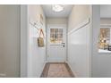 Inviting entryway with white wainscoting, coat hooks, and a view of the front door at 205 Coachman Dr, Garner, NC 27529