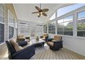 Cozy sunroom with ample natural light, wicker furniture, and serene outdoor views at 205 Olive Field Dr, Holly Springs, NC 27540