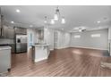 Open concept kitchen with stainless steel appliances, an island, and flows into the living area at 2057 Big Falls Dr, Wendell, NC 27591
