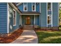 Inviting front porch with a wooden door and steps, creating a warm welcome at 206 Cottrell Dr, Louisburg, NC 27549