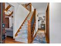 Elegant staircase featuring carpeted steps and wooden banisters at 206 Cottrell Dr, Louisburg, NC 27549