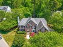 Stately two-story brick home surrounded by lush landscaping and mature trees in a lovely neighborhood at 206 Glebe Way, Cary, NC 27519
