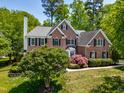 Lovely brick two-story home with manicured lawn, lush landscaping and a classic design at 206 Glebe Way, Cary, NC 27519
