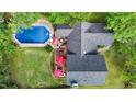 Aerial view of a private backyard featuring a pool, patio area, expansive deck, and beautifully landscaped yard at 2113 Port Royal Rd, Raleigh, NC 27609