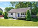 Inviting single-Gathering home with lush front lawn, neatly trimmed shrubs and a vibrant blue front door at 2210 Milburnie Rd, Raleigh, NC 27610
