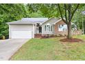 Single-Gathering home with attached garage, manicured lawn and mature shade tree at 2301 Bolingbrook Ln, Raleigh, NC 27613