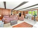 Spacious living area with wood paneled walls, ceiling beams and abundant natural light at 251 Charles Riddle Rd, Sanford, NC 27330