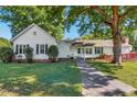 Sprawling one-story home with mature trees and an accessible ramp leading to the entrance at 251 Charles Riddle Rd, Sanford, NC 27330