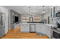 Modern kitchen with white cabinets, stainless steel appliances, and an open layout at 2690 Meadow View Ln, Sanford, NC 27332