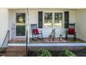 Inviting front porch with rocking chairs, a welcome mat, and lovely decor, creating a cozy entrance at 2717 Jack Rd, Clayton, NC 27520