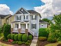 Beautiful home with a covered front porch, stone accents, black shutters, and well-maintained landscaping at 281 N Serenity Hill Cir, Chapel Hill, NC 27516
