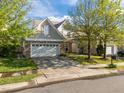 Charming home featuring a stone facade, two-car garage, and well-maintained front yard at 2812 Prospect Pkwy, Durham, NC 27703
