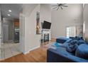 Bright living room featuring a fireplace, high ceilings, and hardwood floors at 2812 Prospect Pkwy, Durham, NC 27703