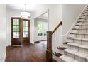 Grand foyer featuring hardwood floors, staircase, and light fixtures at 30 Ocoee Falls Dr, Chapel Hill, NC 27517