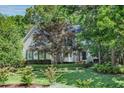 Well-maintained home featuring lush landscaping, a green lawn and mature trees at 300 Livingstone Dr, Cary, NC 27513